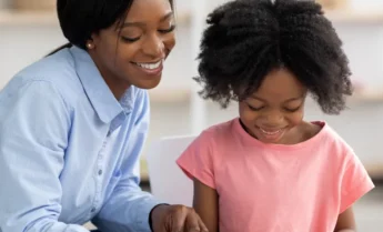 cheerful-pretty-african-american-woman-teaching-li-2022-12-16-08-19-56-utc-2