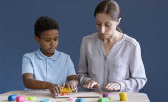 kid-doing-occupational-therapy-session-with-psychologist-scaled